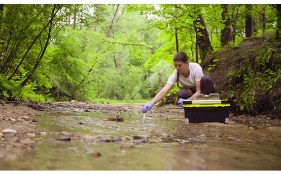 Woman sifts thru Local Creek