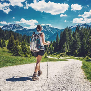 climate change concerns as lady hikes in beautiful mountainscape